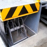 scissor lift table behind PVC-roller blind