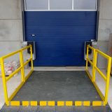 Loading lift table with safety railing and roll-off protection